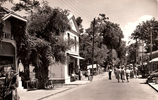 Année 1950. Au second plan la boutique. Marie-Jo, robe bla